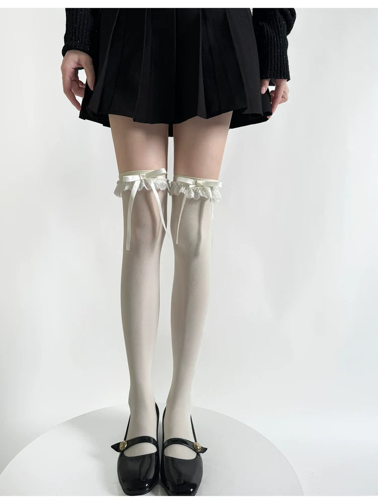 Milky white over-the-knee socks with lace trim and ribbon ties styled with black Mary Jane shoes