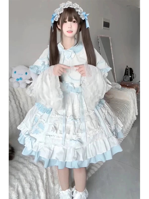 Blue-and-white JSK with layered ruffles and cape styled on a model.