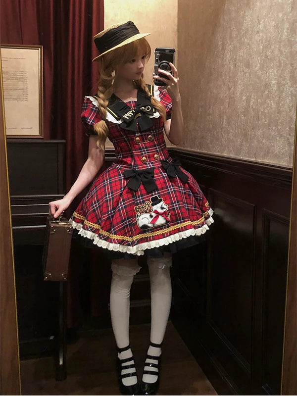 Creamy red plaid one-piece dress with black bows and a scalloped white lace hem