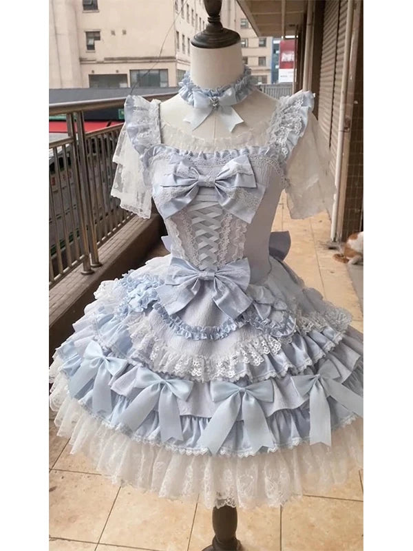 Creamy Lolita dress set in blue with layered ruffles, bows and a train on a mannequin.