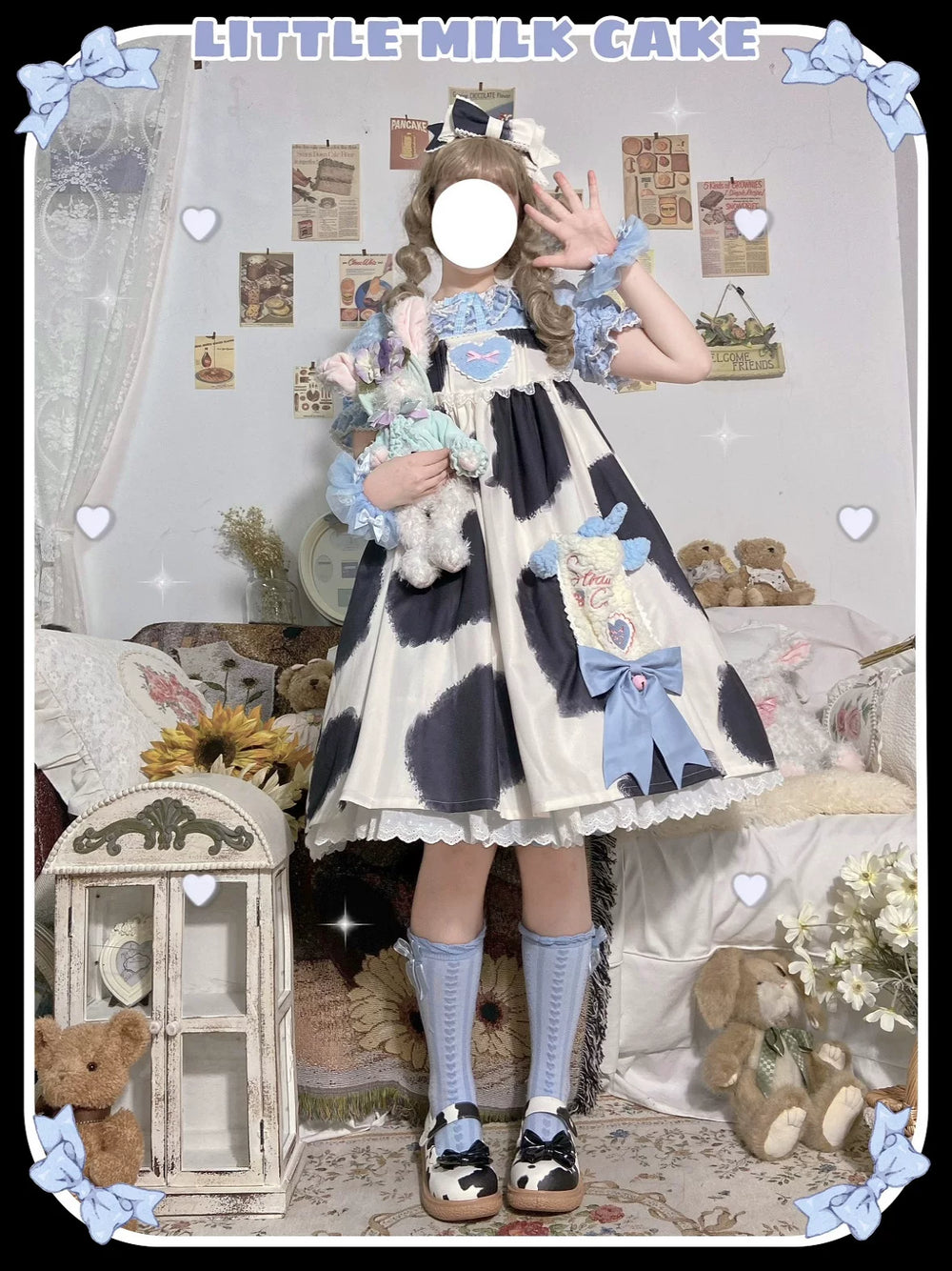 Model wearing a black-and-white cow-print Little Milk Cake JSK dress with blue accents.