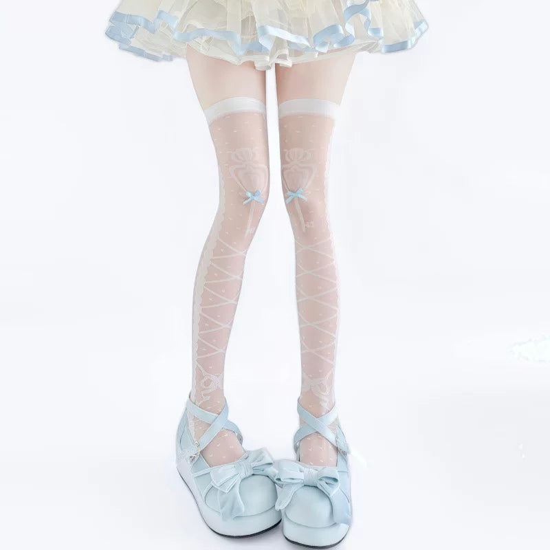 White over-knee socks with pale printed motifs and bow details styled with pink shoes.