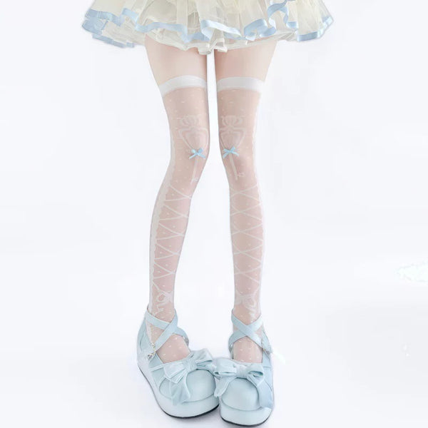 White over-knee socks with pale printed motifs and bow details styled with pink shoes.