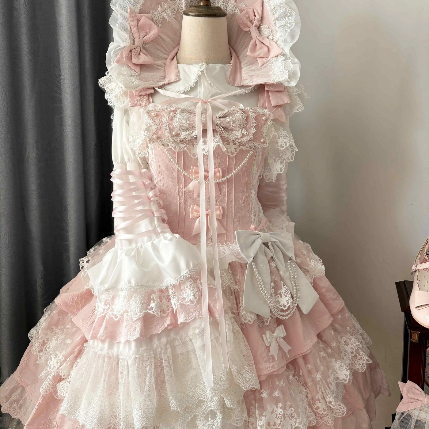 Coordinating wide-brimmed lace bonnet with ribbon ties, included in select variants