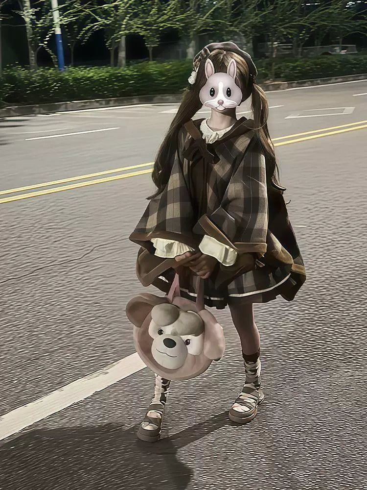 Tiramisu plaid cape and dress coordinate photographed outdoors