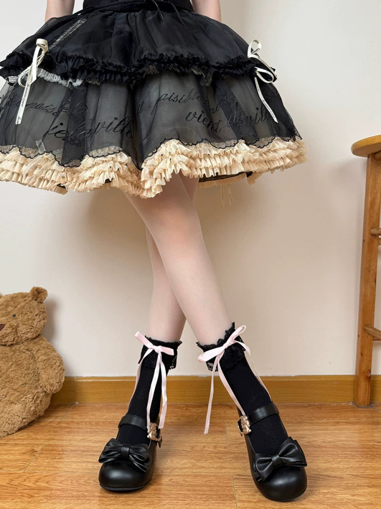 Pink and black lace-trimmed mid-calf socks with ribbon ties