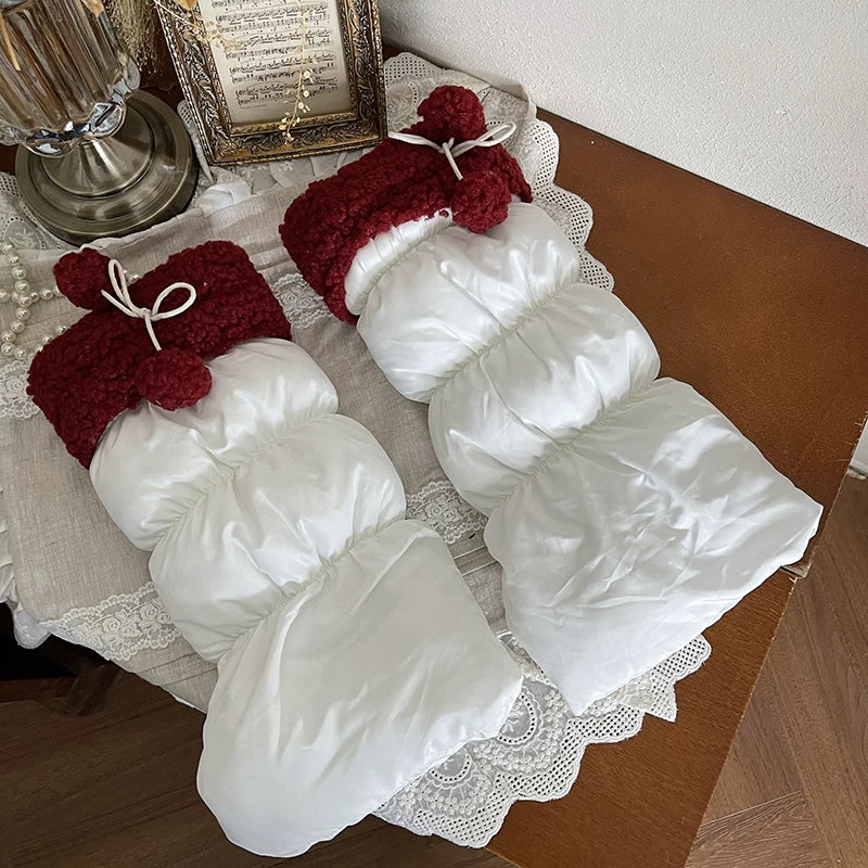White gathered lamb-fleece sock covers with pom-pom ties worn over platform shoes.
