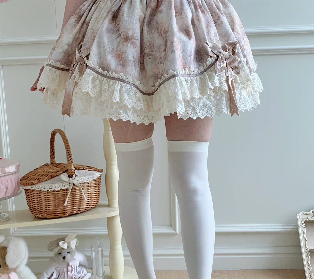 White velvet over-the-knee socks shown with a cat-paw non-slip detail.