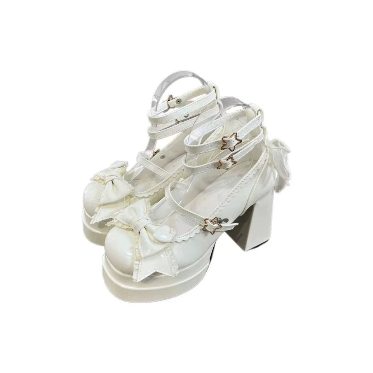 White bow-accent shoes with ankle straps, star-shaped side details, and chunky heels.