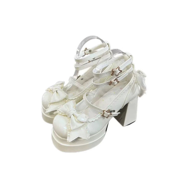 White bow-accent shoes with ankle straps, star-shaped side details, and chunky heels.