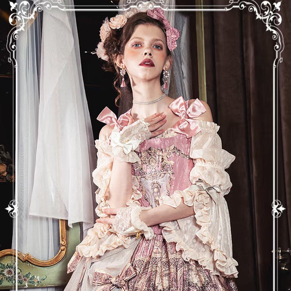 Pink and cream ruffled skirt-set styling with ornate bodice details, shown on a model.