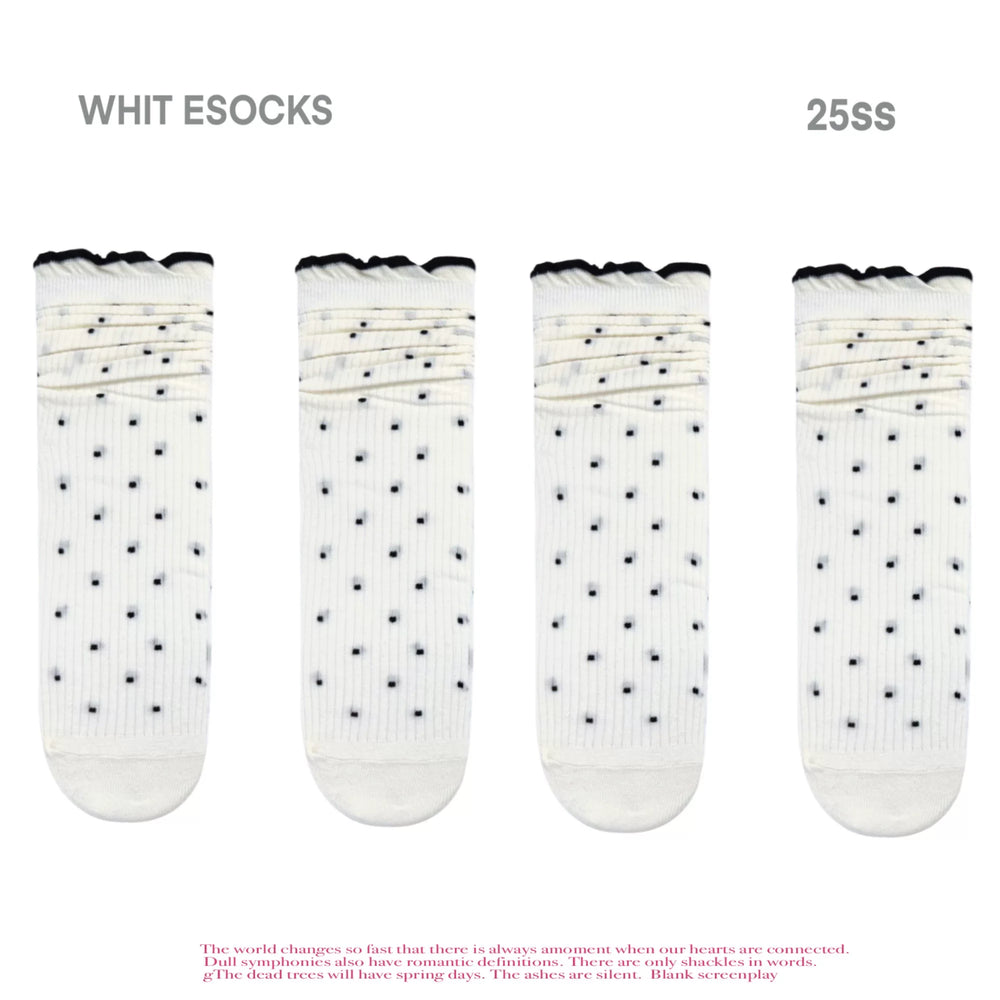White polka-dot ribbed slouch socks with dark scalloped cuffs displayed against a white background.