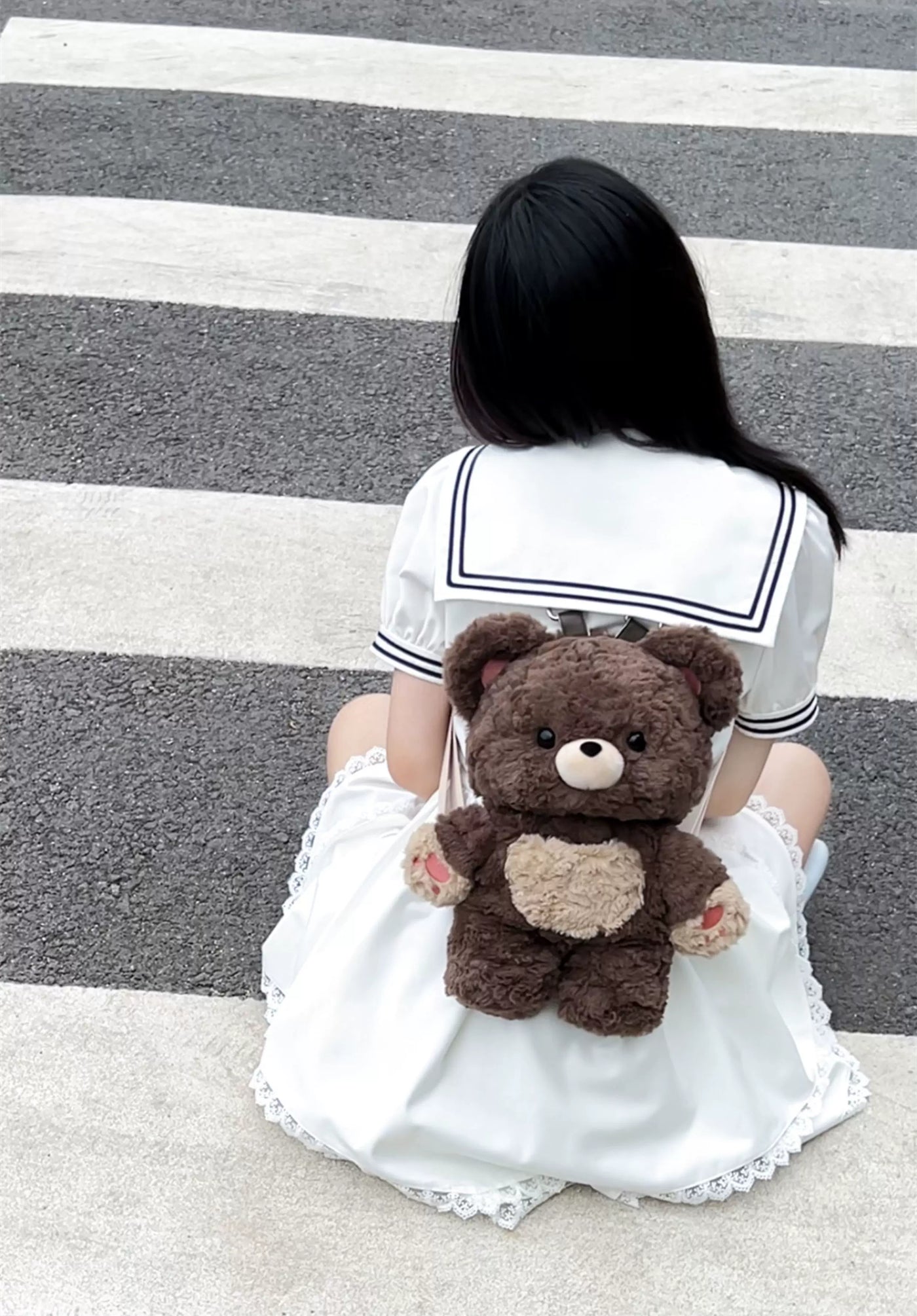 Brown Little Bear Guli plush bear backpack with a cream muzzle, rounded ears and pink inner ears