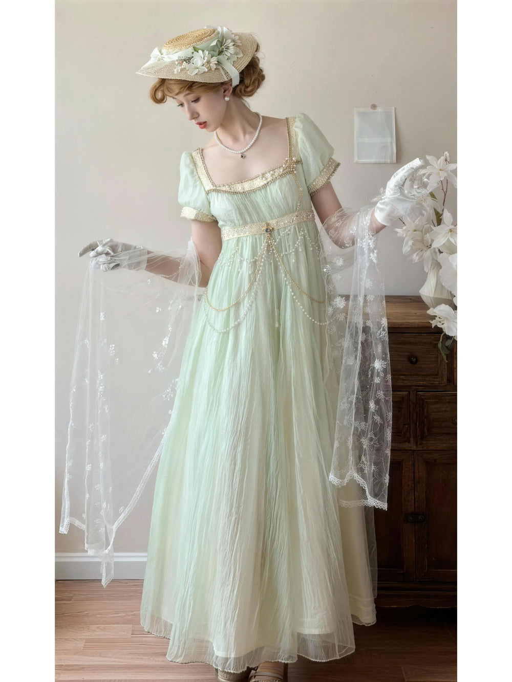 Mint green Lolita dress with gold trim, puff sleeves and pearl chains.