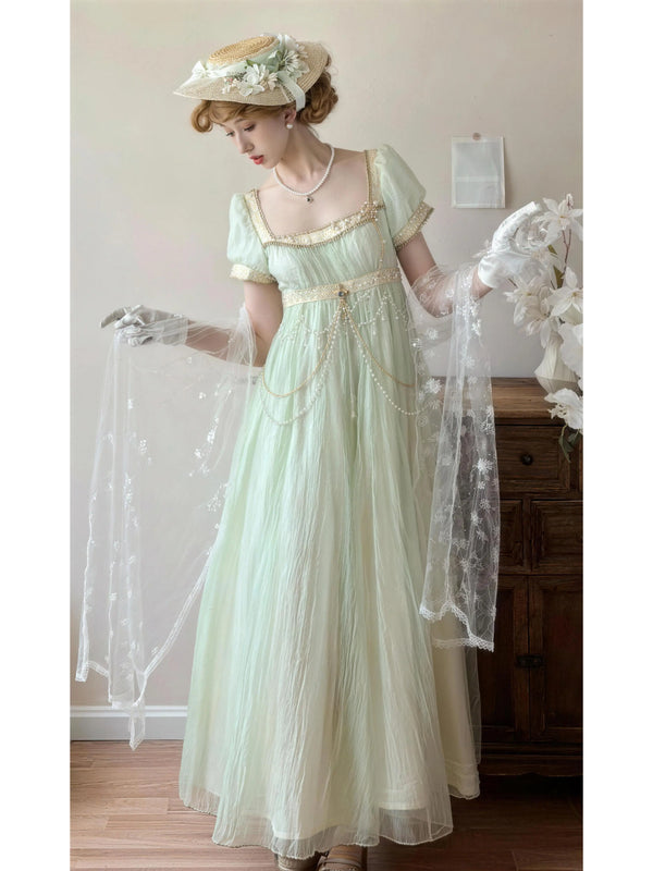 Mint green Lolita dress with gold trim, puff sleeves and pearl chains.