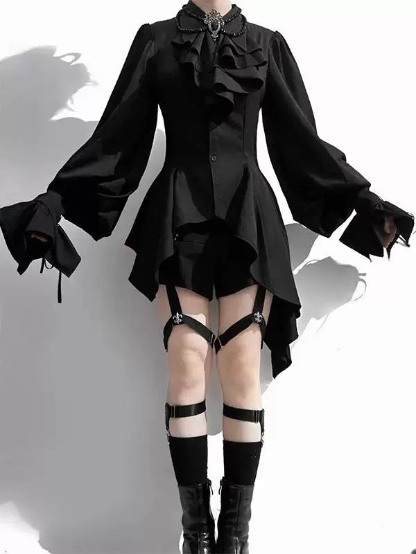 Black blouse with layered front ruffles, puff sleeves and an asymmetrical hem.