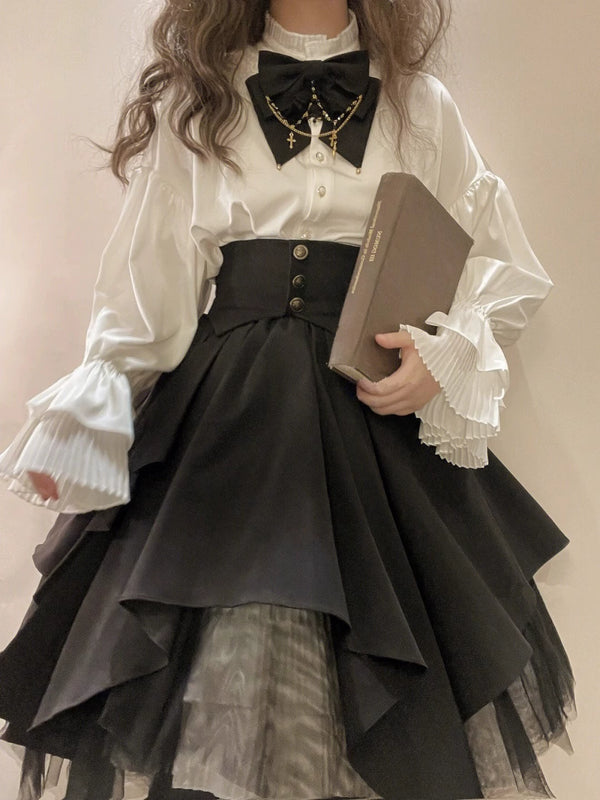 Creamy black-and-white blouse and skirt set with pleated balloon sleeves, waist panel and bow tie.