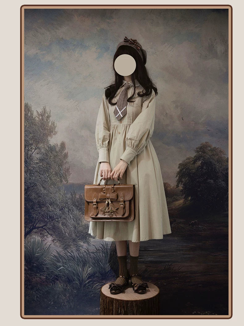 Styled model wearing a gray striped one-piece dress and woolen coat set with a white blouse, tie and hat.