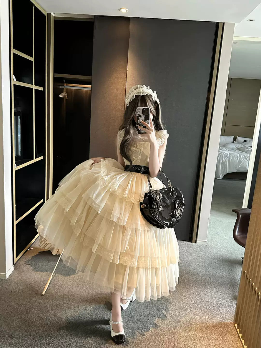 Natural-cream tiered Lolita OP dress with a black waist belt.