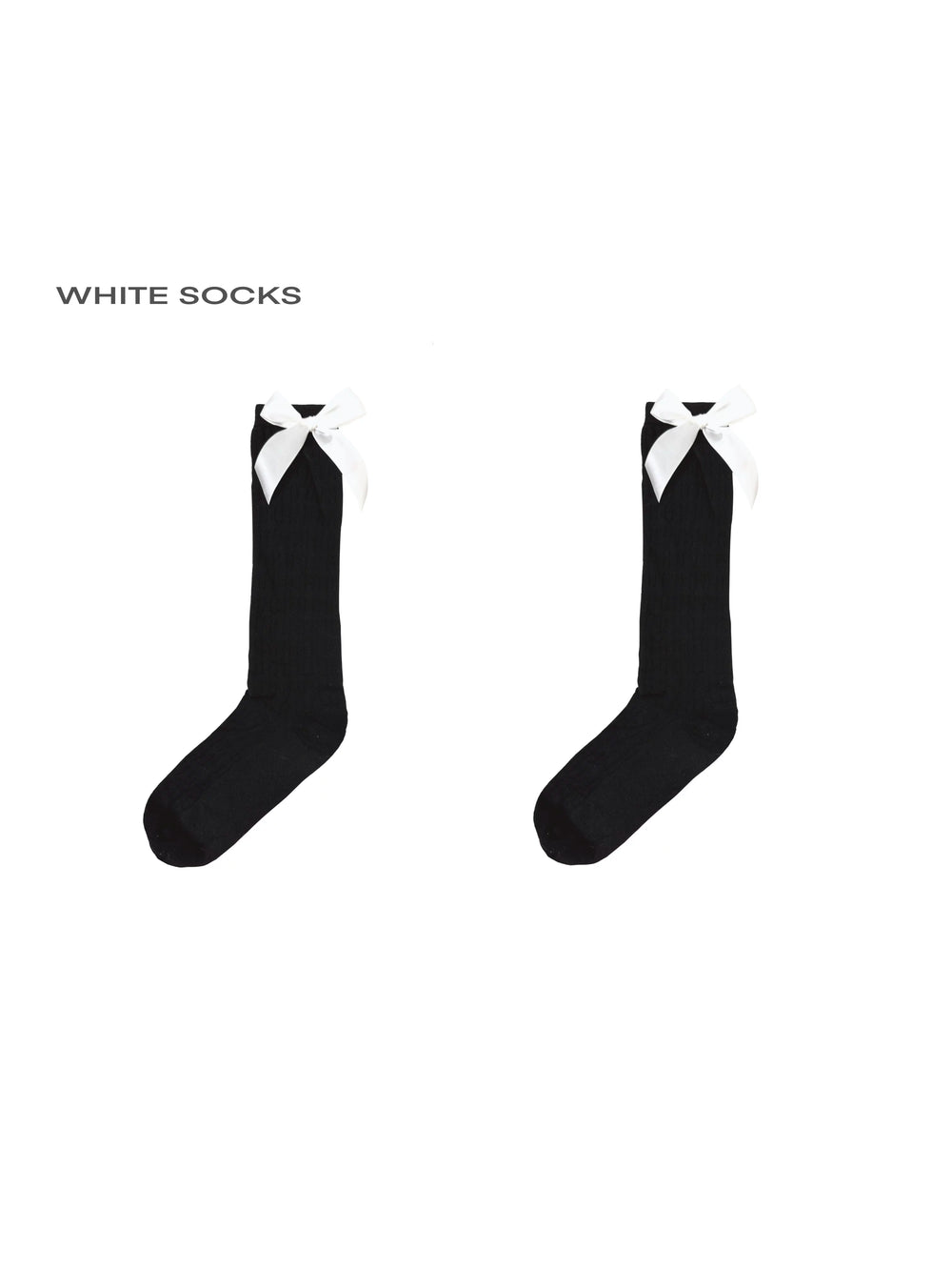 Model wearing white knee-high socks with black heel bows.