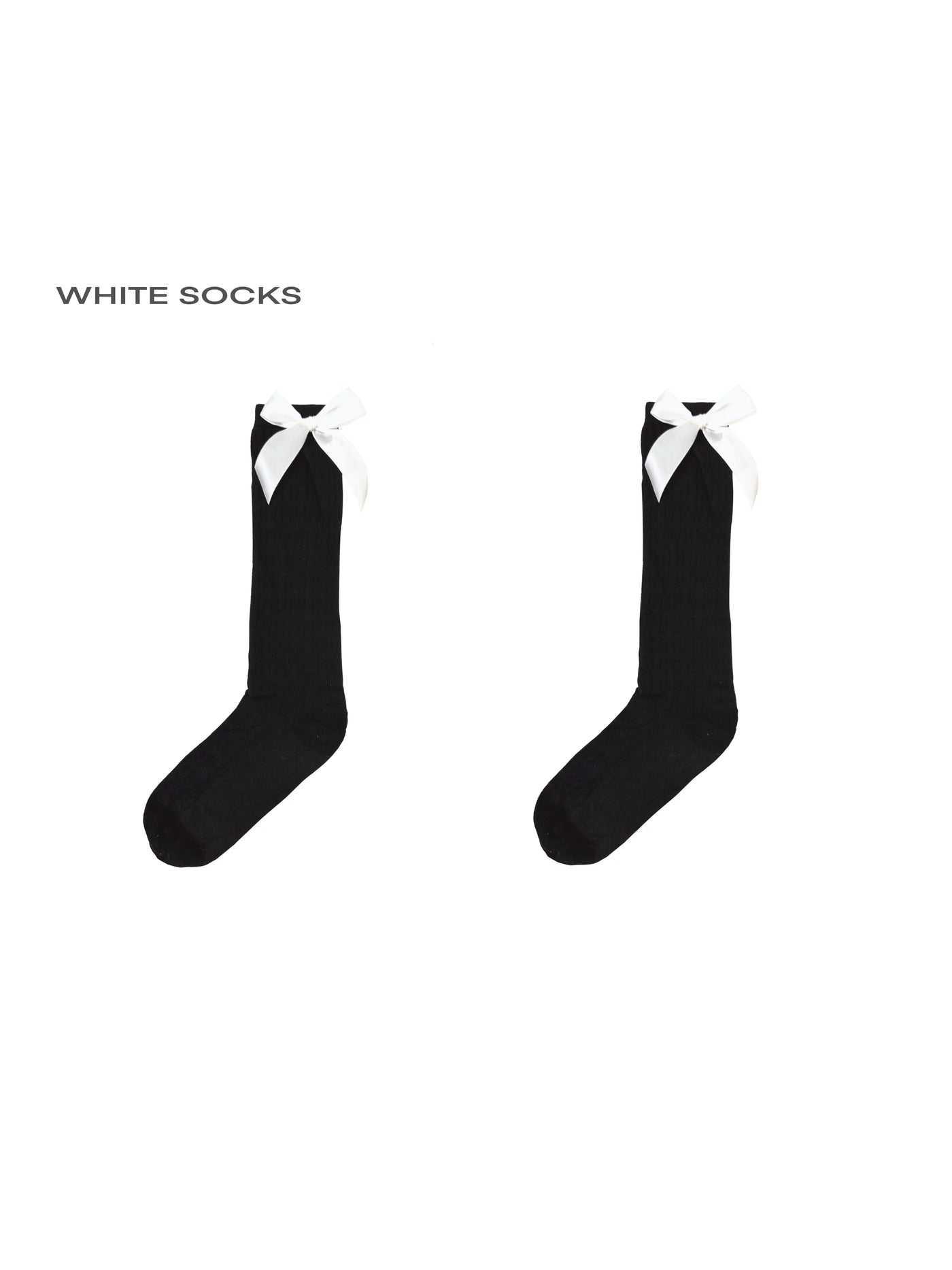 Model wearing white knee-high socks with black heel bows.
