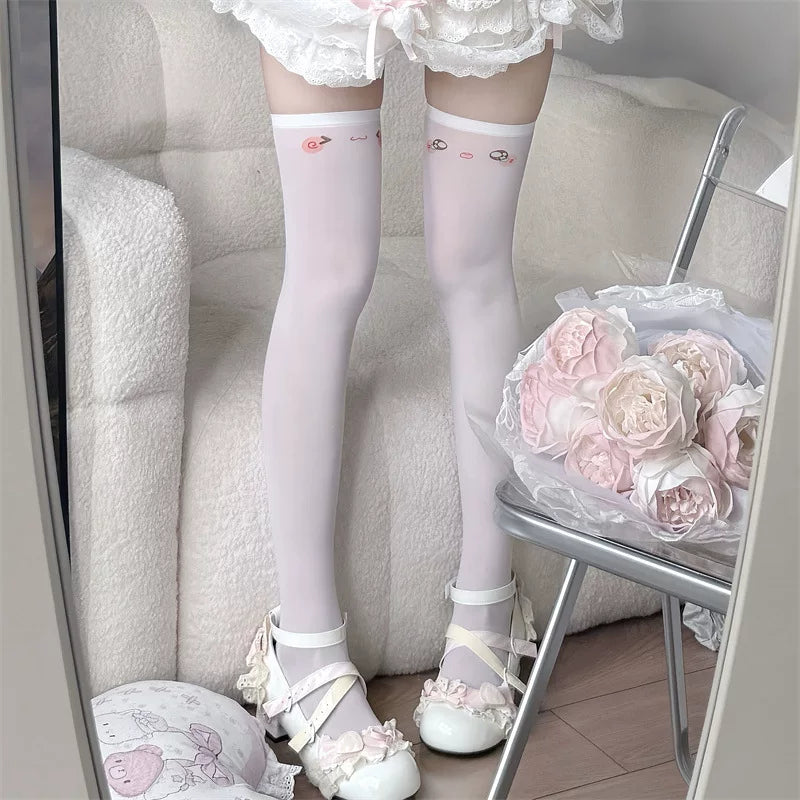 White over-knee socks with small emoticon prints near the upper band