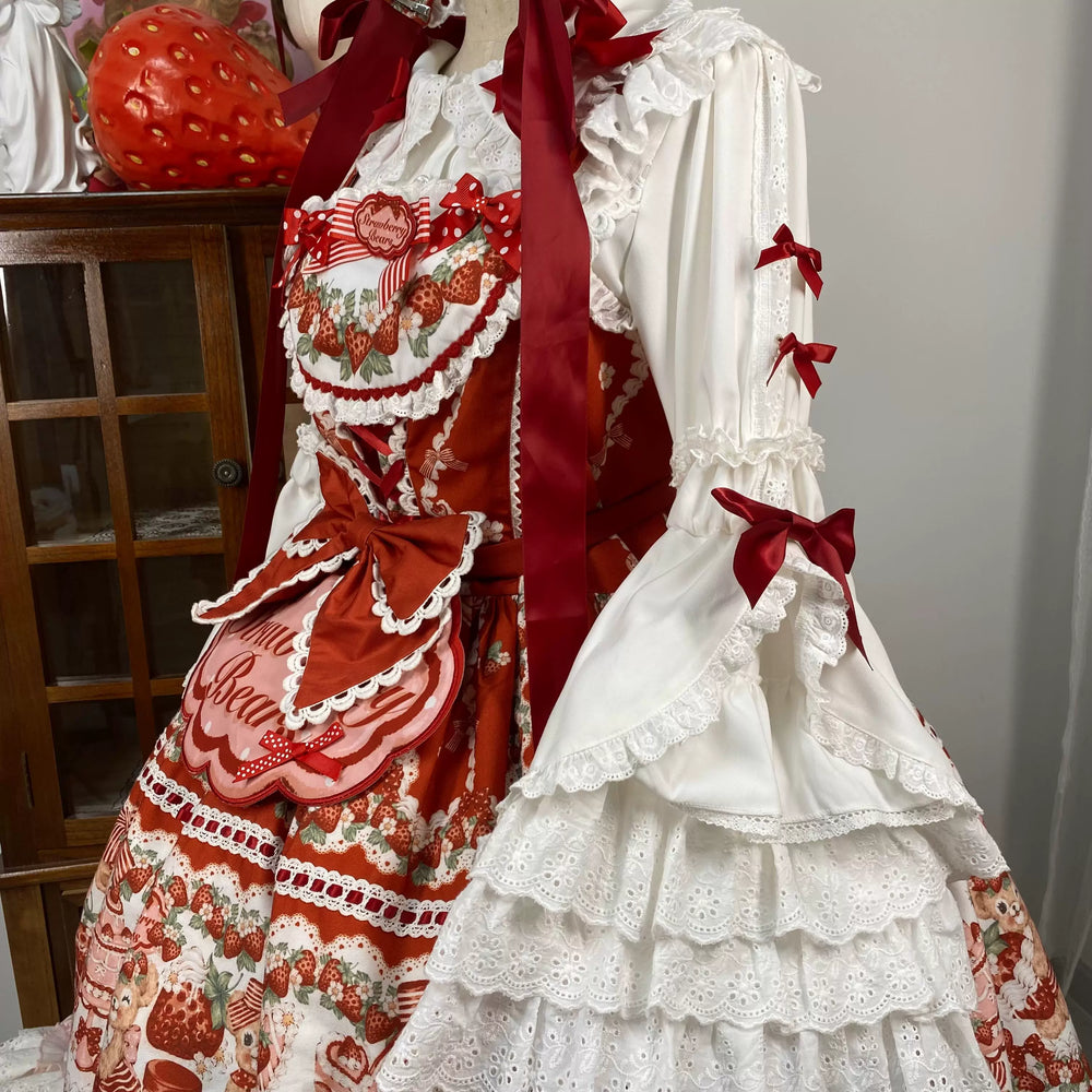 White hime-sleeve blouse with red bows and a strawberry motif shown on a model.