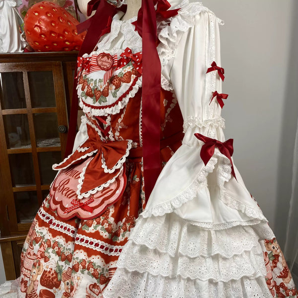 White hime-sleeve blouse with red bows and a strawberry motif shown on a model.