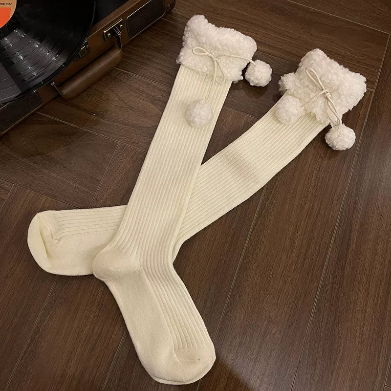 Ivory mid-calf socks with fluffy cuffs, lace edging and pom-pom ties
