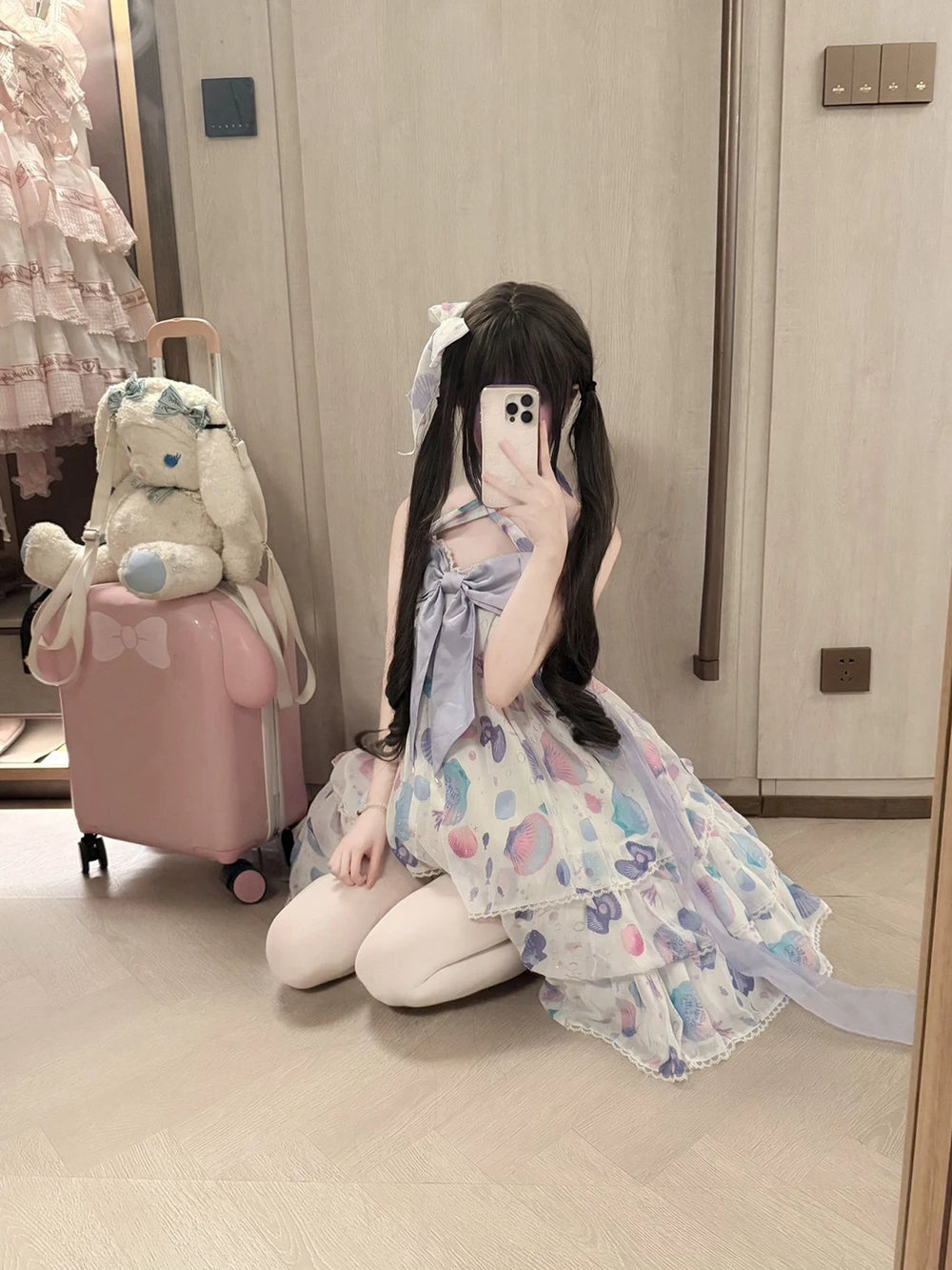 Creamy white shell-print JSK dress with a large purple bow, shown in front and seated styling images.