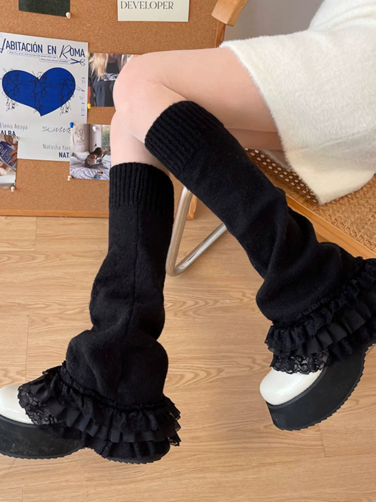 White ribbed leg warmers with layered lace ruffles styled with platform shoes.