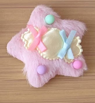 Fluffy pastel star-shaped hair clip with ribbons and appliqué details