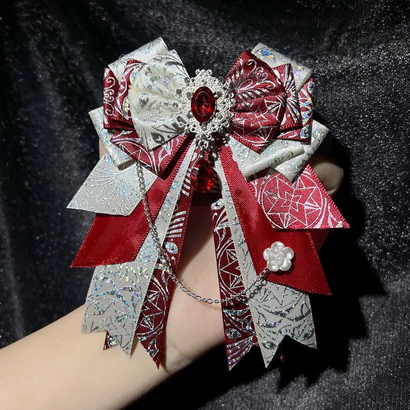 xxc230589 - Snowflake Diamond Bow - Layered bow brooch with a dangling chain