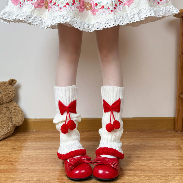 White and red scrunch socks with oversized bows and dangling pom-poms