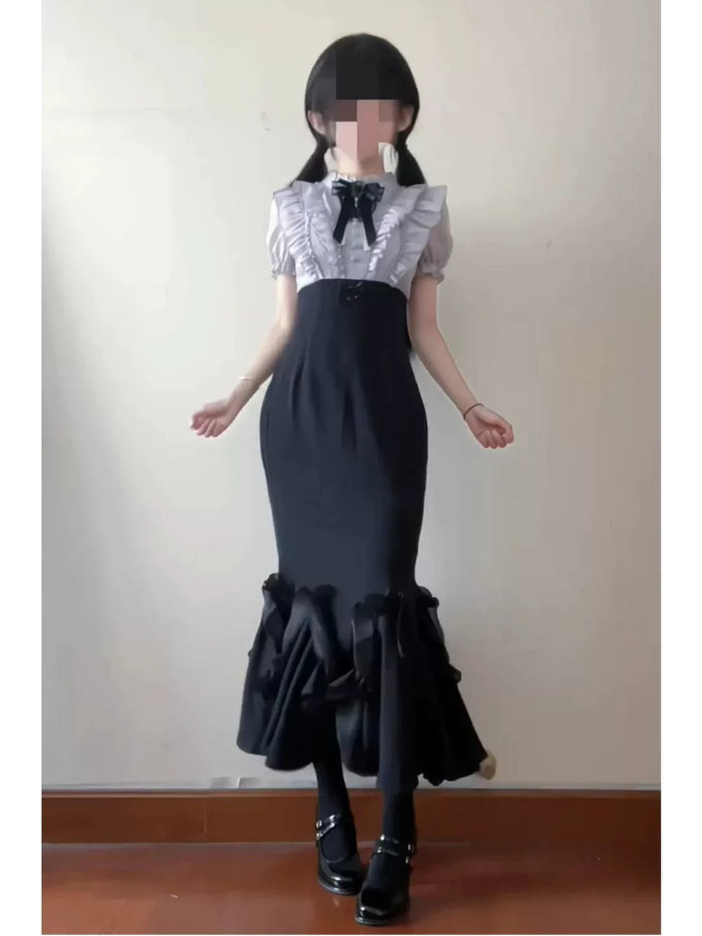 Black-purple high-waisted dress with a light short-sleeve top and ruffled hem.