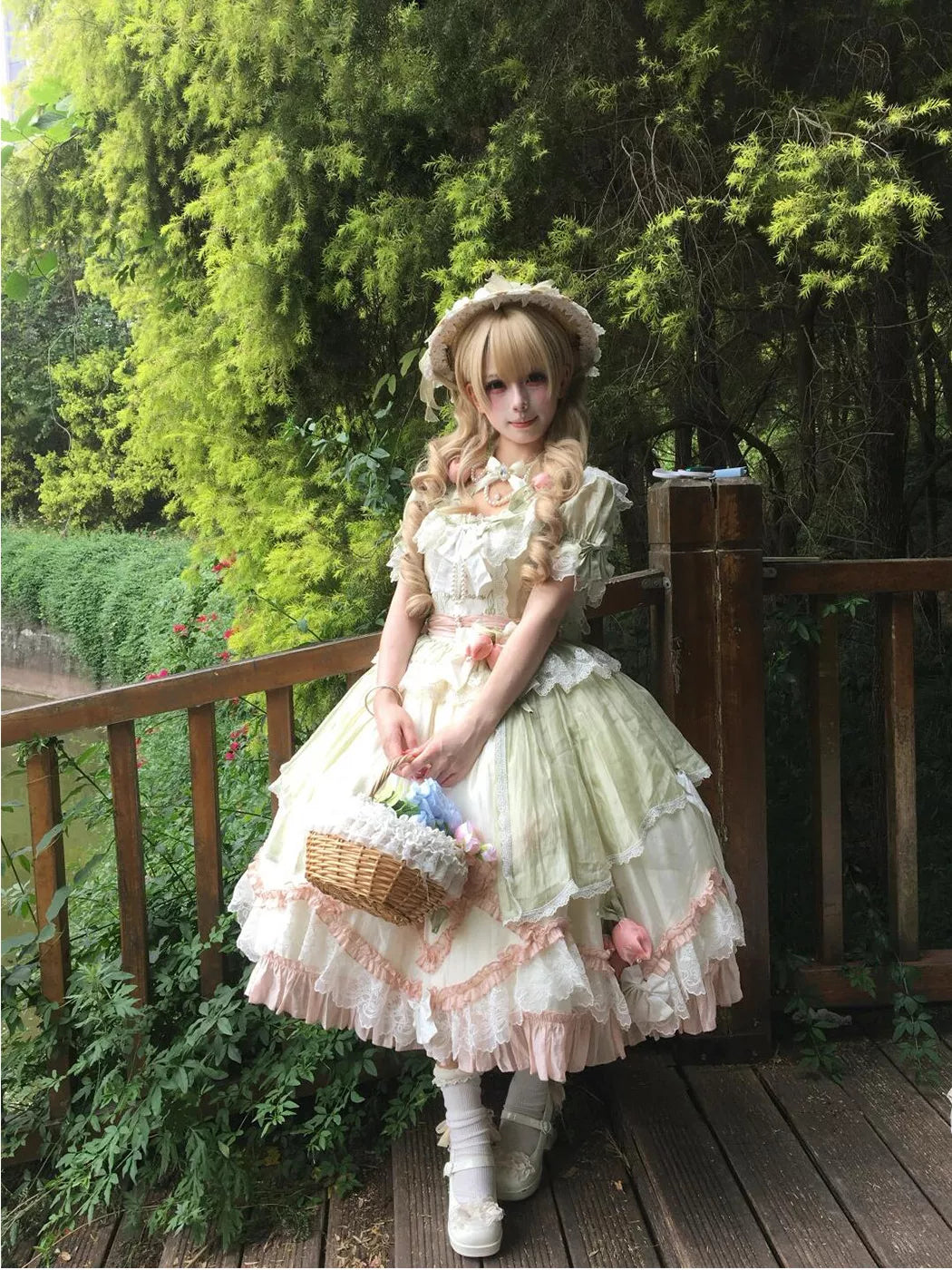Green-pink short-sleeve OP dress with layered lace-trimmed skirt worn outdoors.