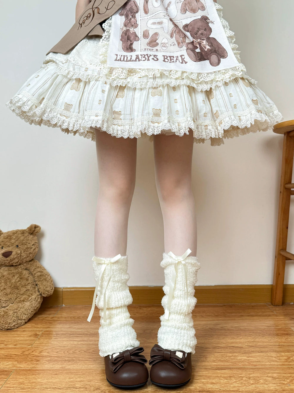 Ivory ruched leg warmers with long ribbon bows and brown shoes