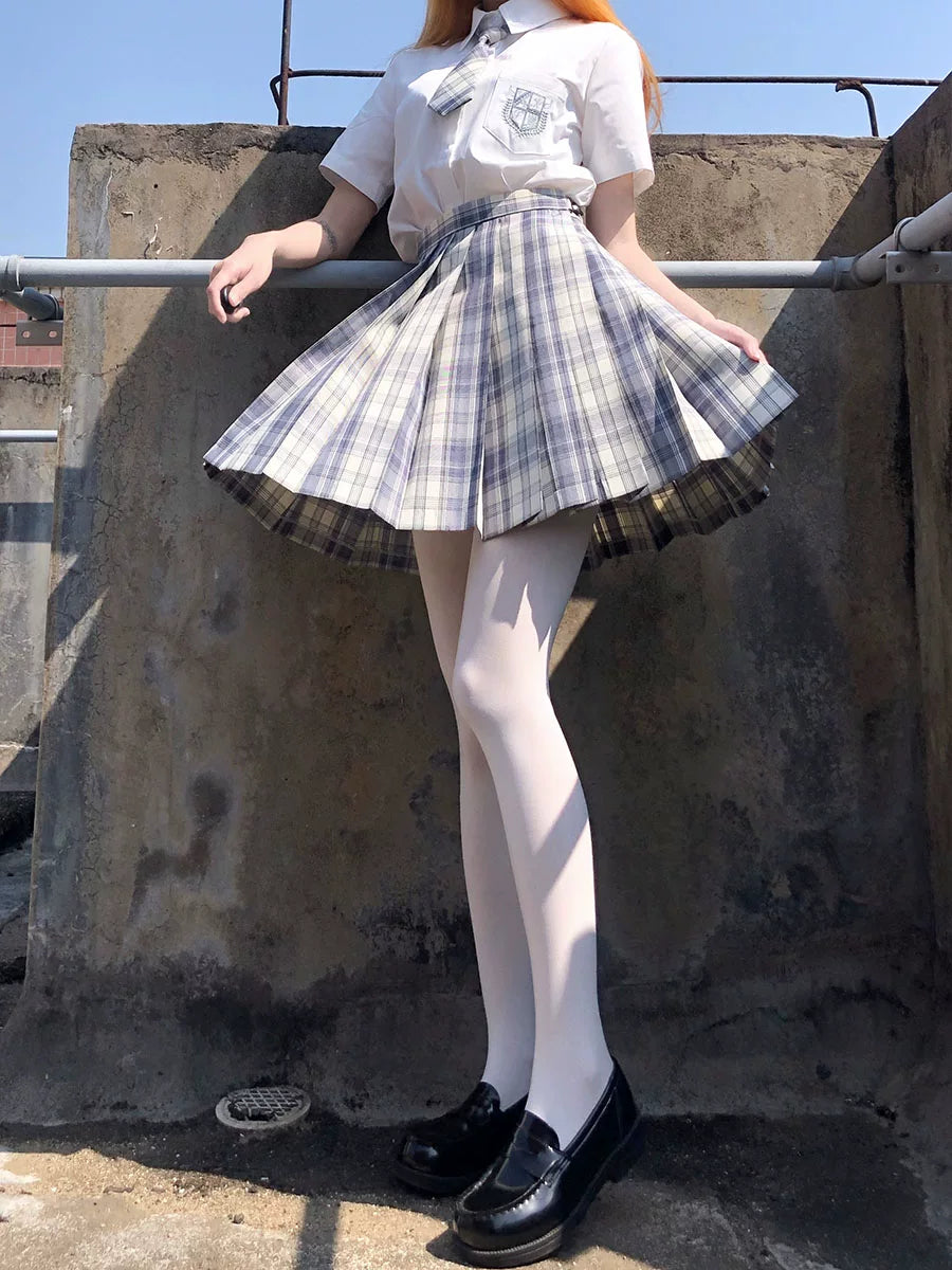 White tights styled with a plaid school-inspired skirt and a pink Lolita dress.