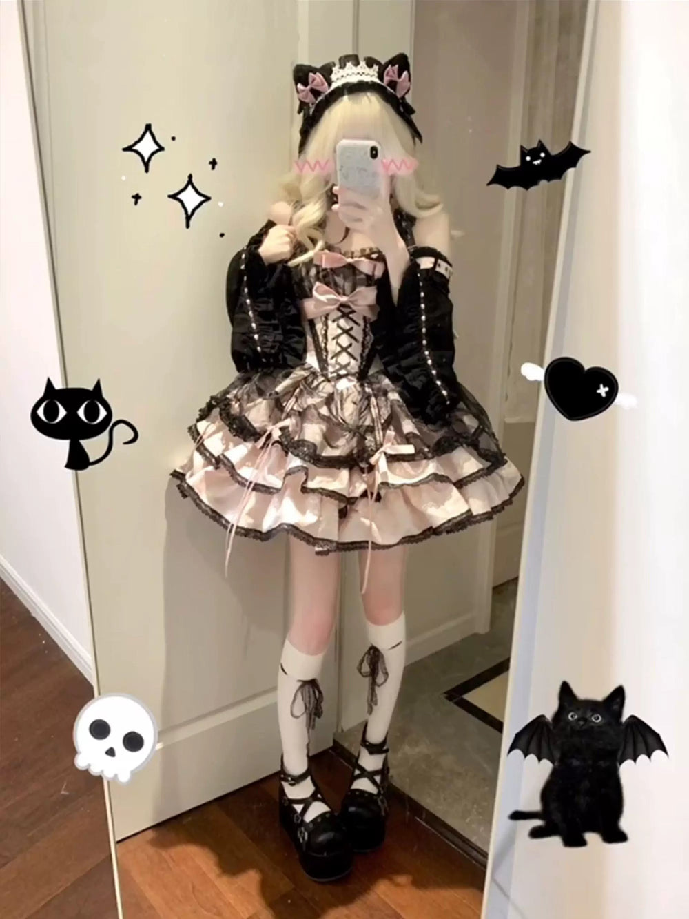 Black-pink layered suspender dress with hand sleeves and pale pink bows.