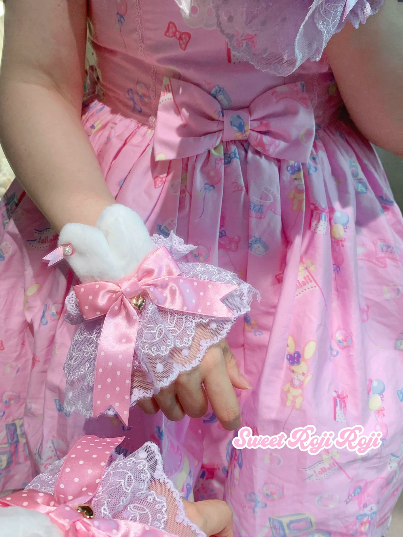 Pink lace hand sleeve with bunny-ear accents, polka-dot bow and white bunny details