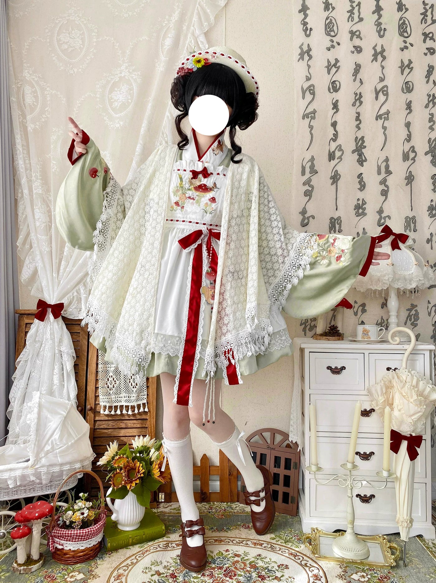 White floral lace shawl with scalloped edging and long fringe styled over a green and white outfit