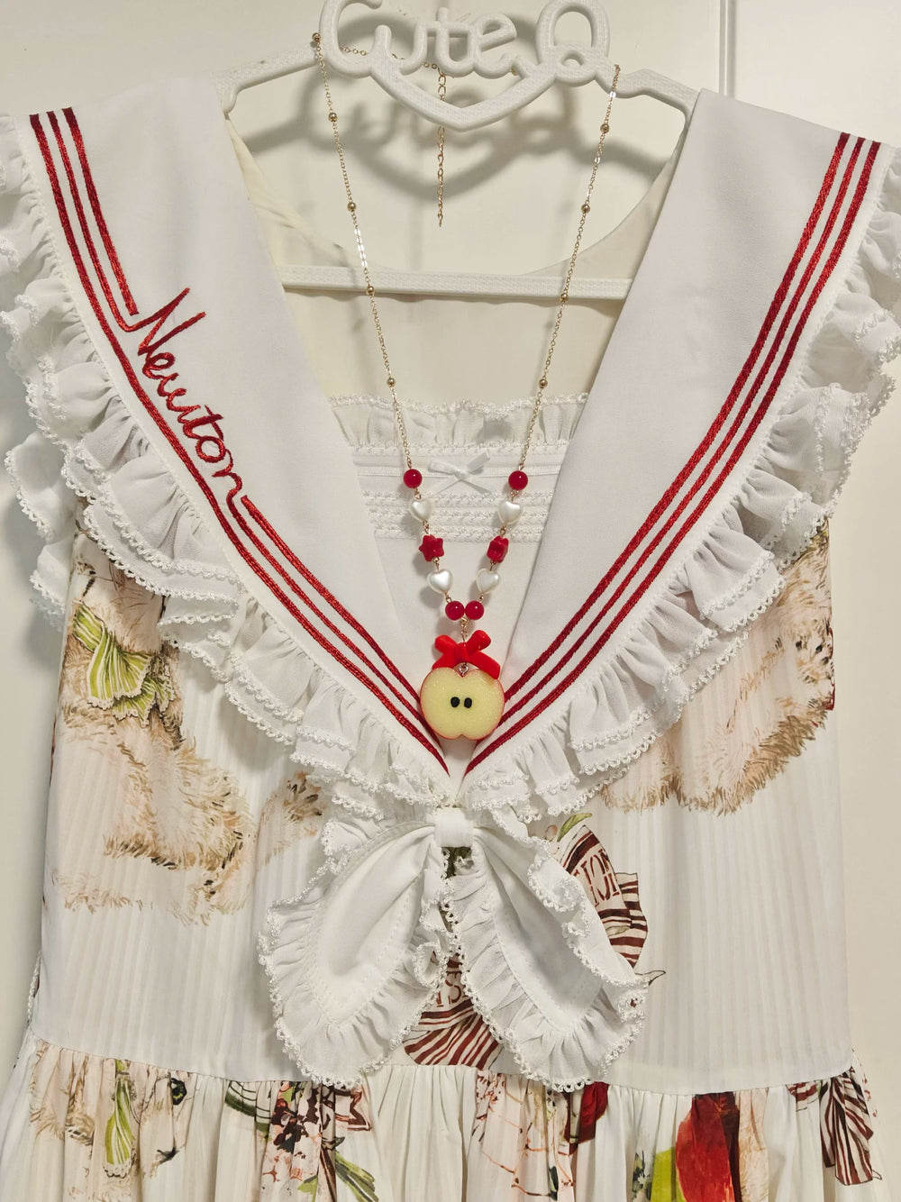 Handmade apple necklace with glossy apple pendant, bow detail and layered beads