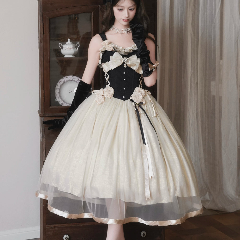 Black and ivory rose-adorned JSK with a full skirt and train on a model.