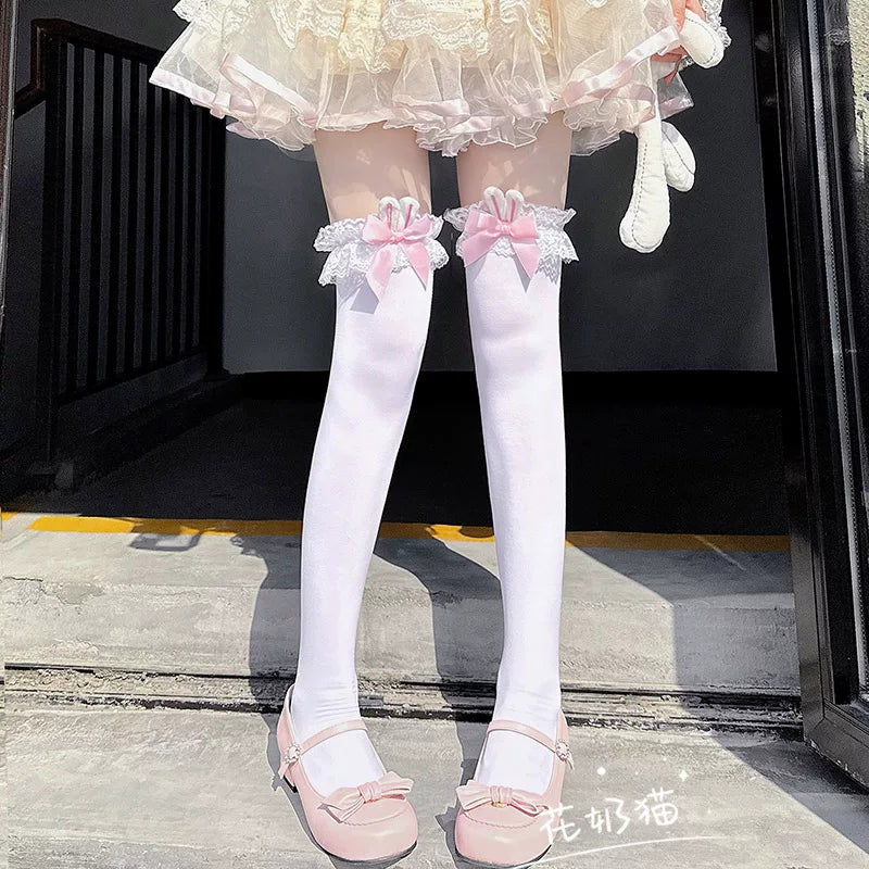 White over-the-knee Lolita socks with pink satin bow, bunny ears, and scalloped lace cuff