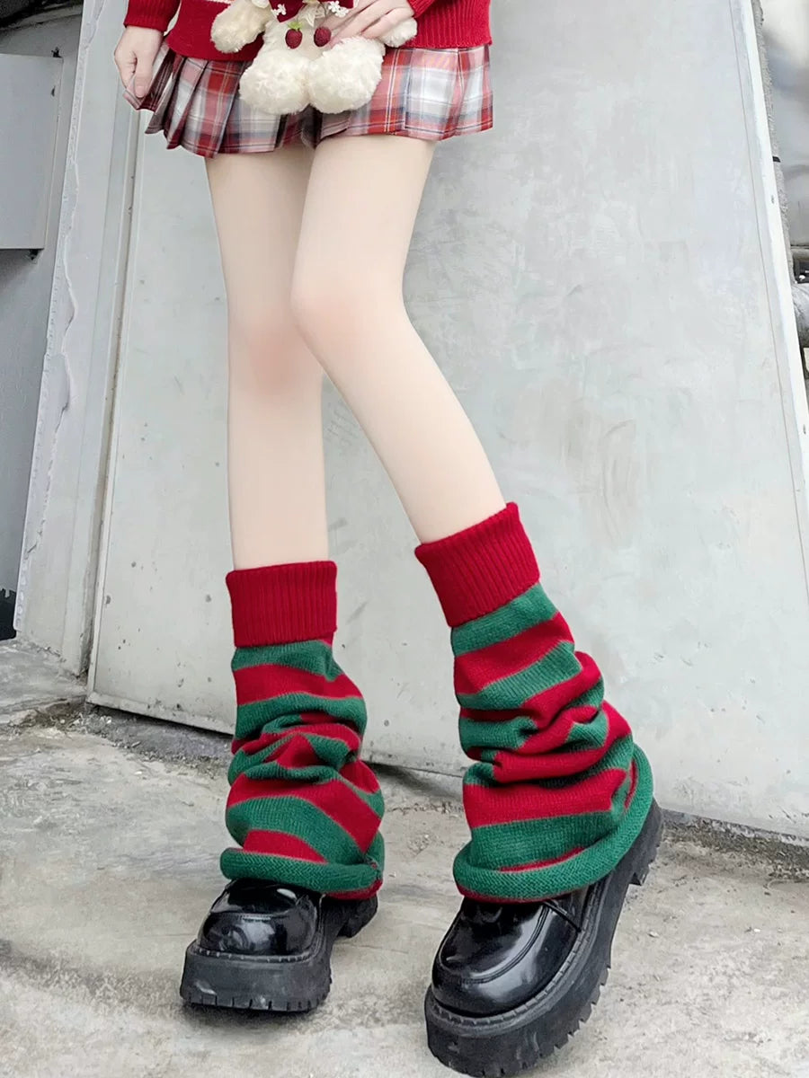 Red and green striped scrunched leg-warmer socks with red ribbed cuffs over black platform shoes