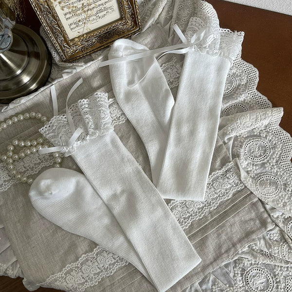White gothic lolita sock sleeves with lace trim, cross pendants, and rivet details