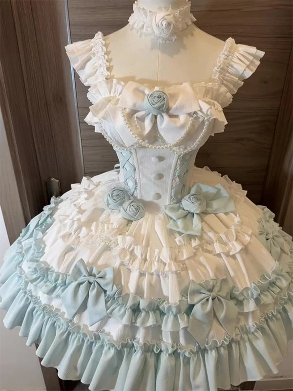 Mint green and white ruffled JSK with rose rosettes and a full layered skirt on a mannequin.
