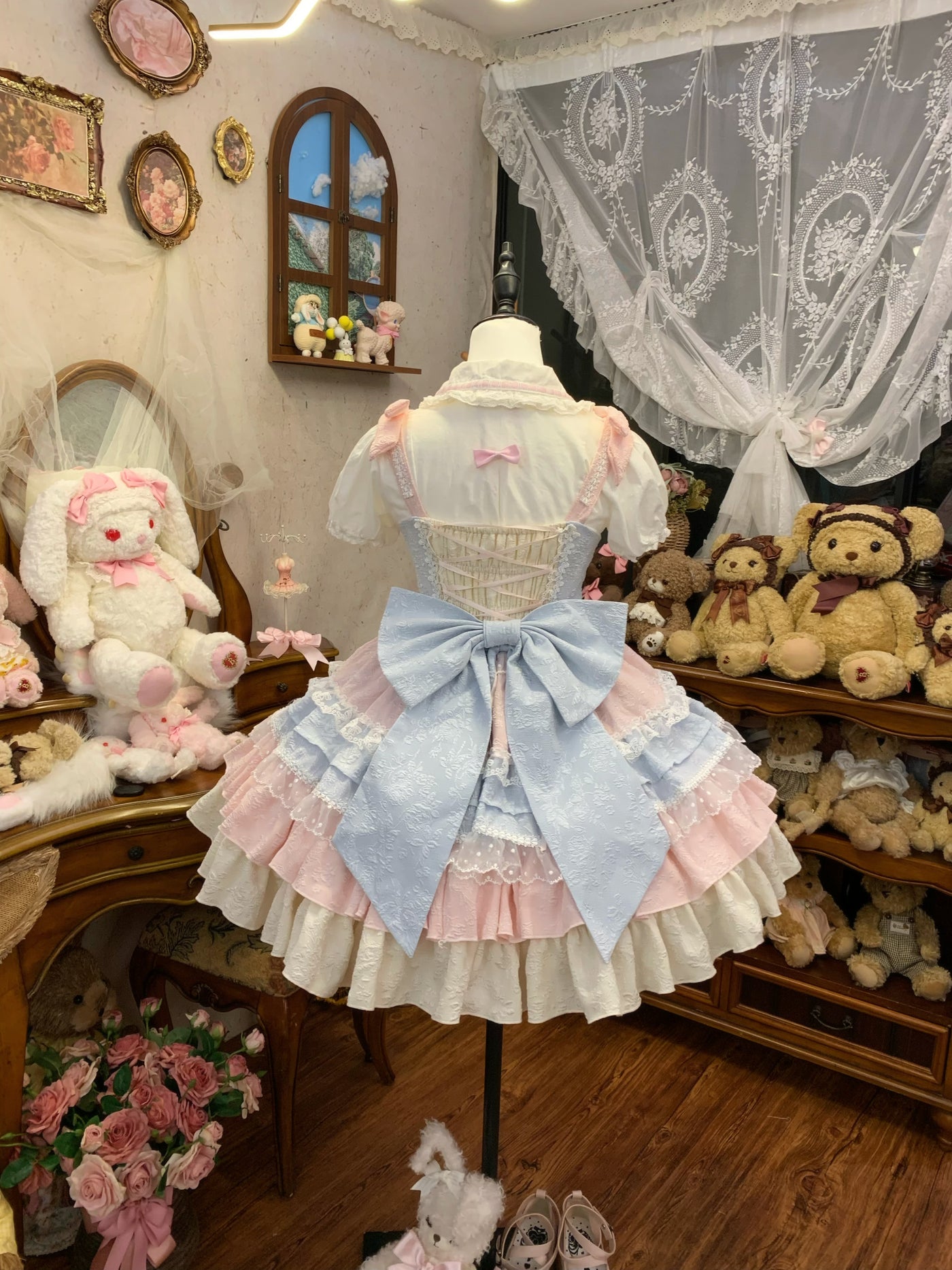 Close-up of JSK collar and bodice, showing Peter Pan collar with pink bows and central light blue bow