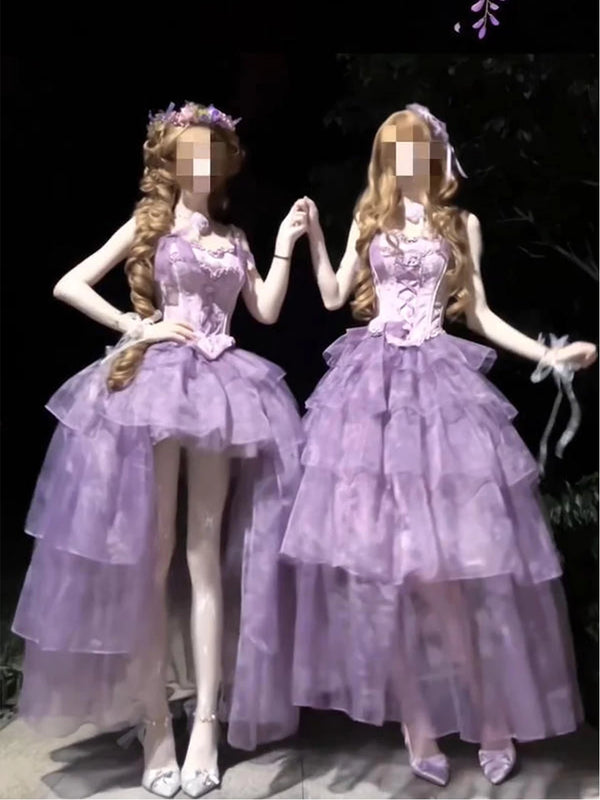 Two purple tiered dresses with lace-up bodices displayed side by side in a dark setting.