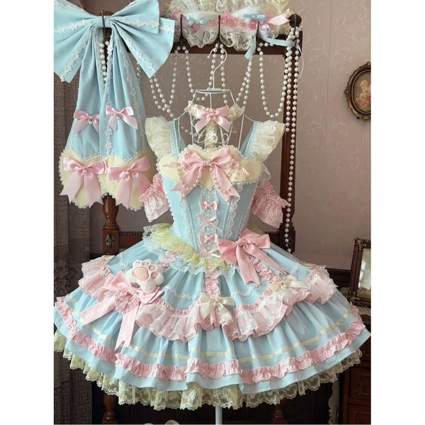 Blue and pink JSK dress displayed with layered bows, lace and matching accessories.